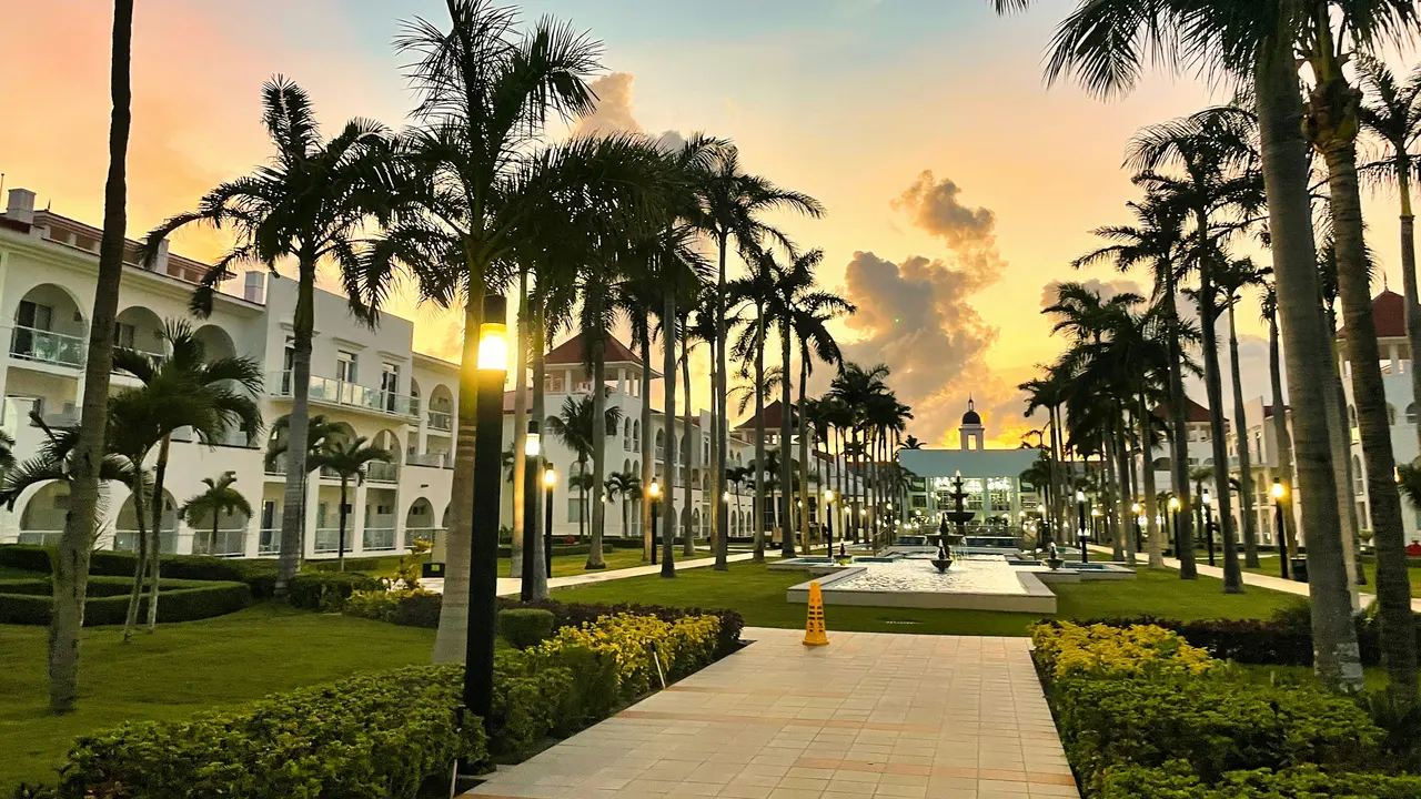 Hotel entrance between palm trees at sunset in Playa del Carmen