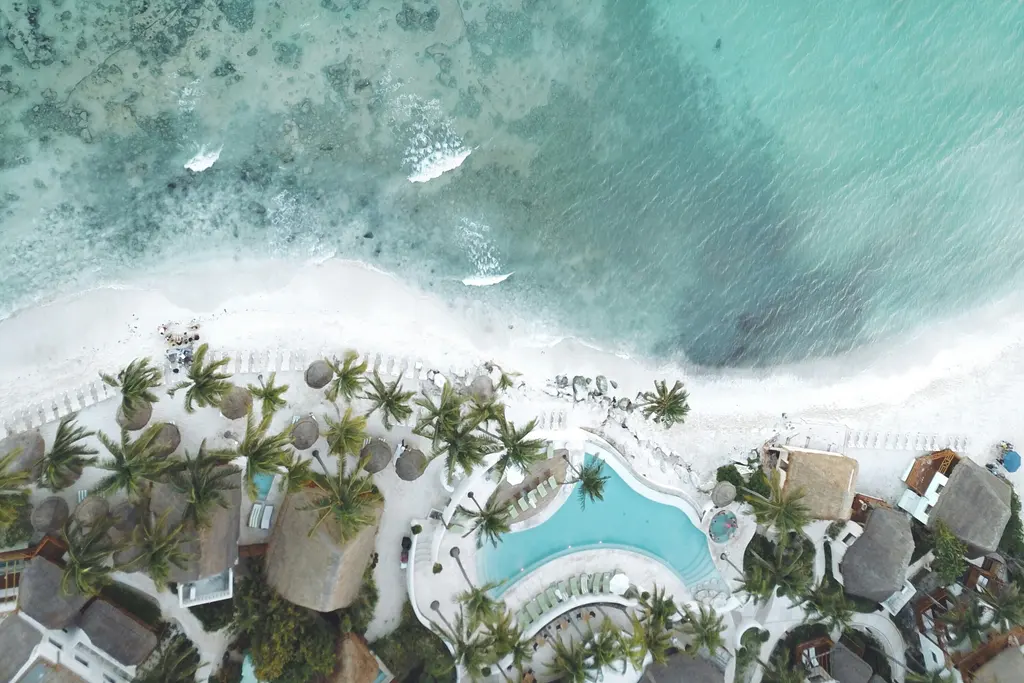 Aerial view of the turquoise sea and a hotel in Playa del Carmen